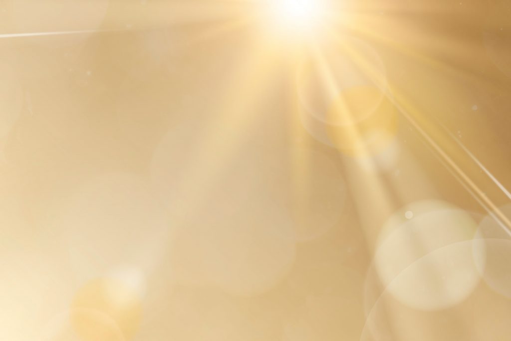 Natural light lens flare on gold background sun ray effect